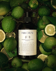 Bottle of shampoo with green bergamot citrus and leaves on a dark background