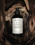 smoked vanilla redwood body cleanser in a natural wood setting
