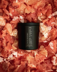 Black candle on a bed of grapefruit peels