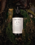 Bottle of sea palm cypress shampoo surrounded by natural elements