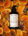 sicilian orange blossom body lotion surrounded by sliced oranges and flowers