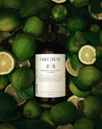 Bottle of Fable & Ruin cleanser surrounded by bergamot citrus and pepper