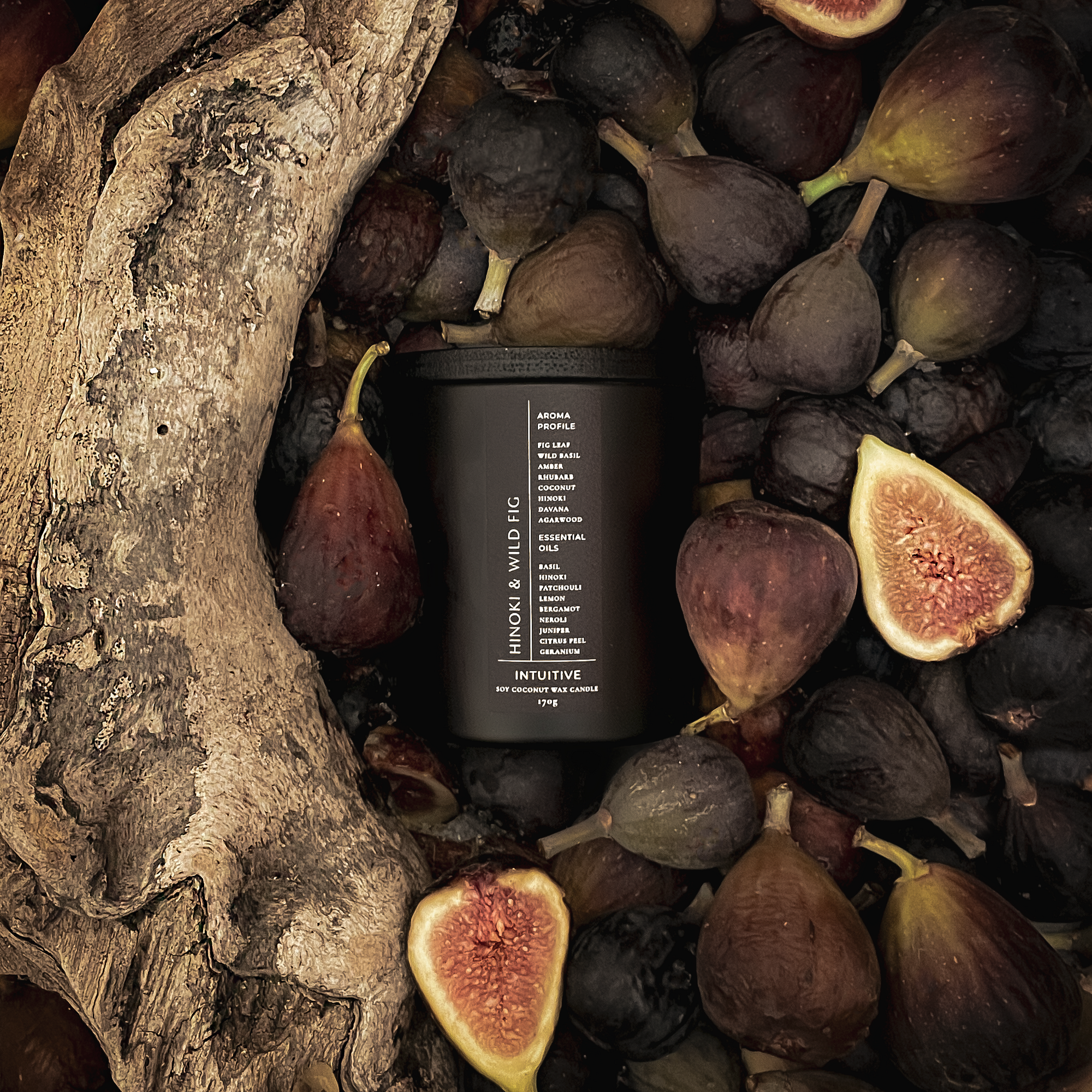 Black candle surrounded by figs and wooden elements