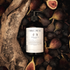 Bottle of body lotion surrounded by figs and wood