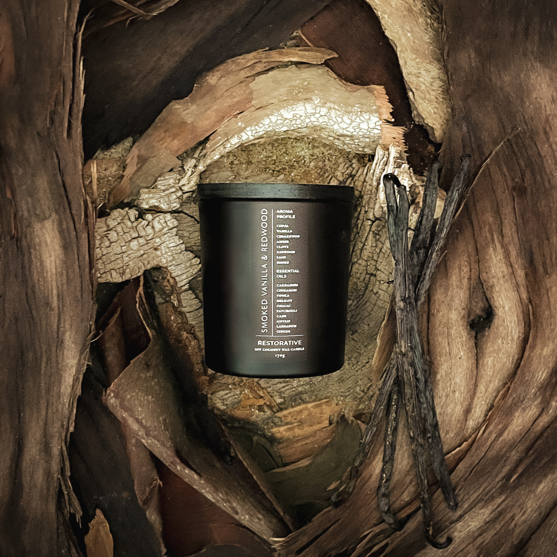 Black smoked vanilla redwood candle container on a wooden surface