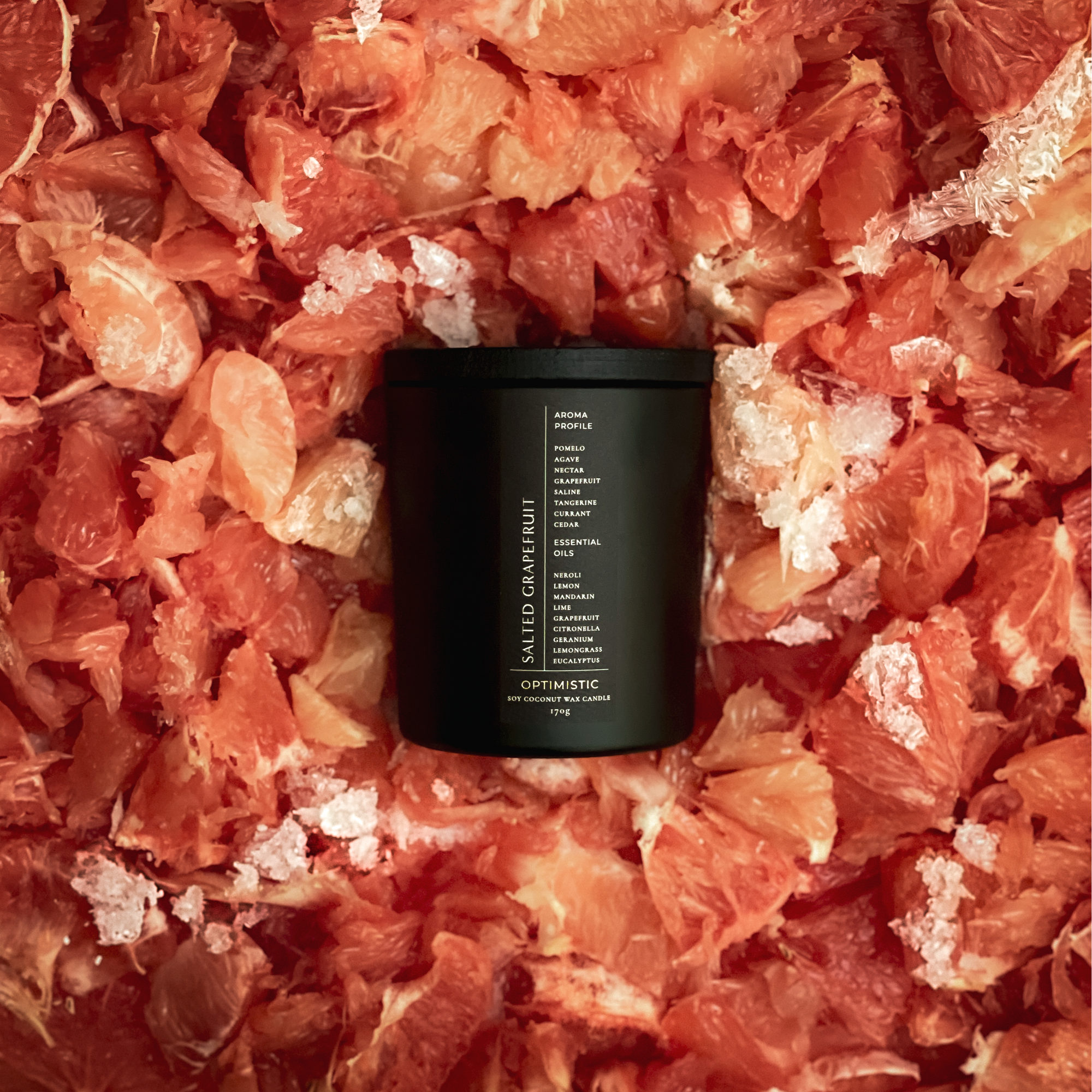 Black candle on a bed of grapefruit peels