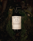 Sea palm cypress body cleanser surrounded by greenery