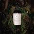 Bottle of hair conditioner surrounded by natural elements
