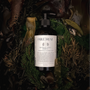 Bottle of sea palm cypress shampoo surrounded by natural elements