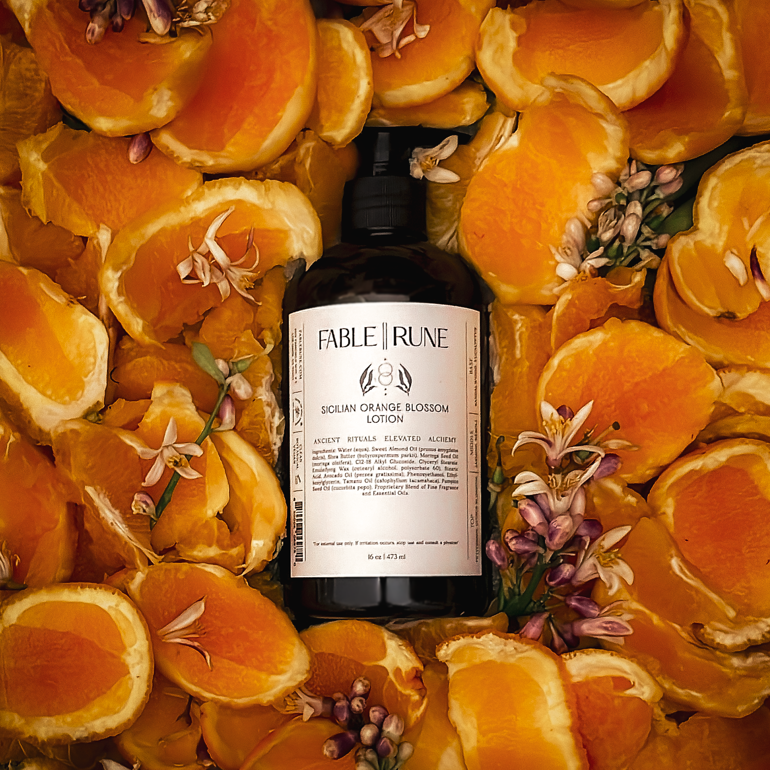 sicilian orange blossom body lotion surrounded by sliced oranges and flowers