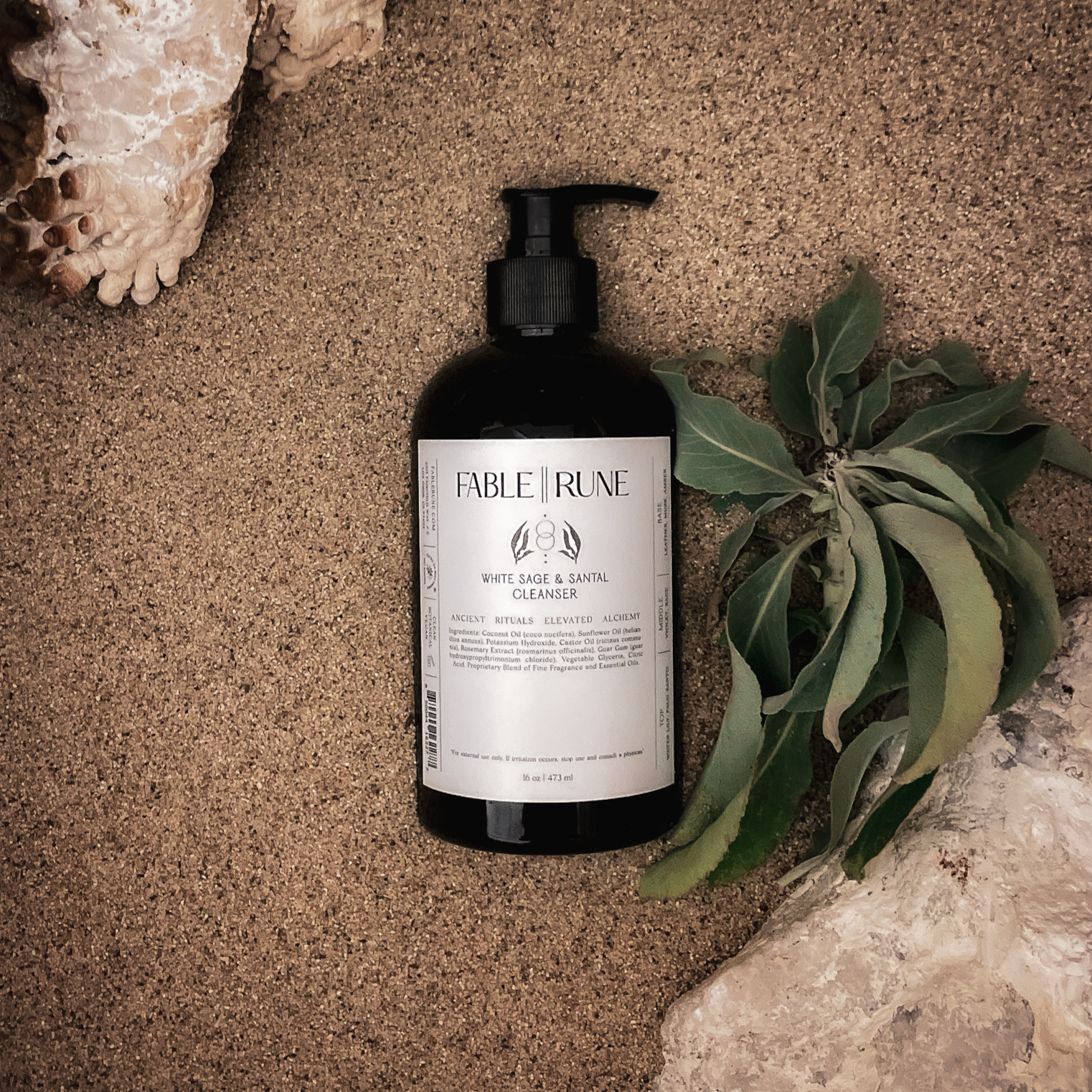 white sage santal body cleanser with rocks and leaves
