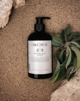 white sage santal body cleanser with rocks and leaves